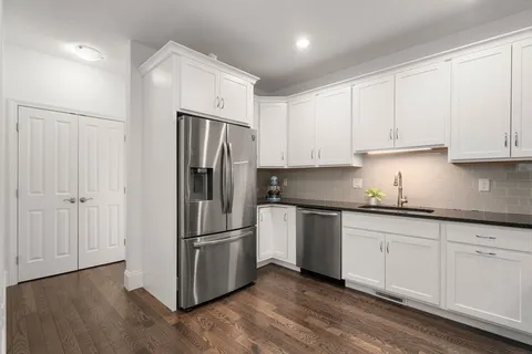 a kitchen with granite countertop wooden cabinets and stainless steel appliances