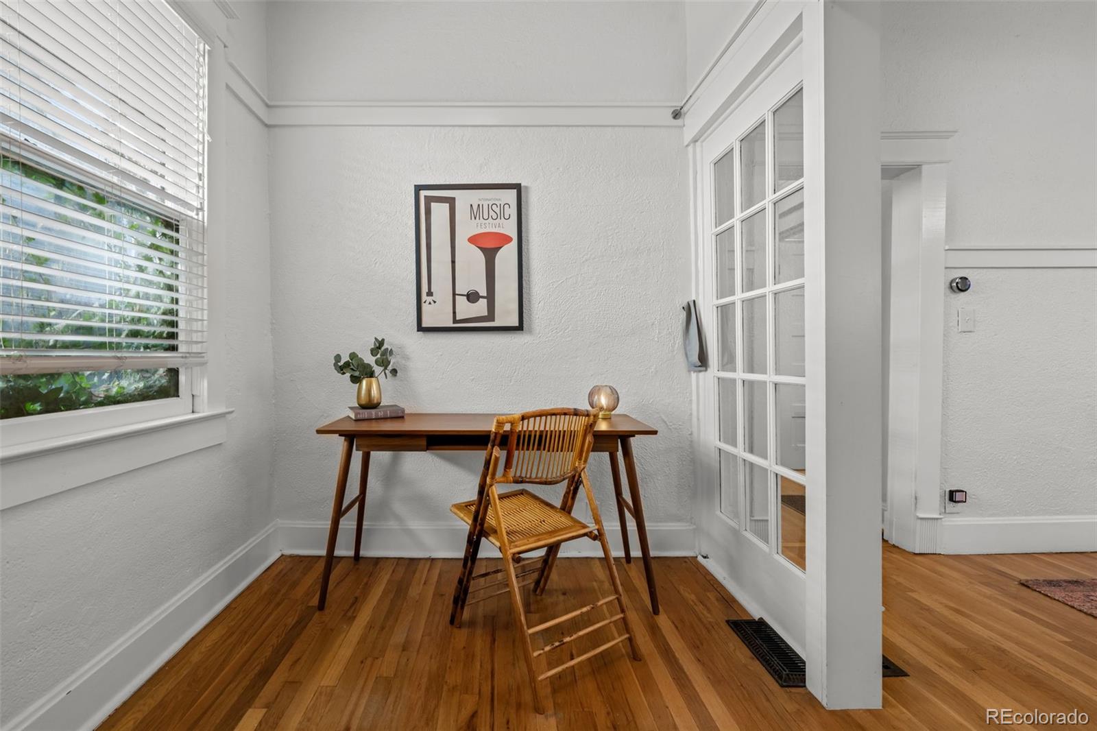 2922 Welton Street Denver, CO 80205 - Photo 11 of 42 a view of a workspace with furniture and a window