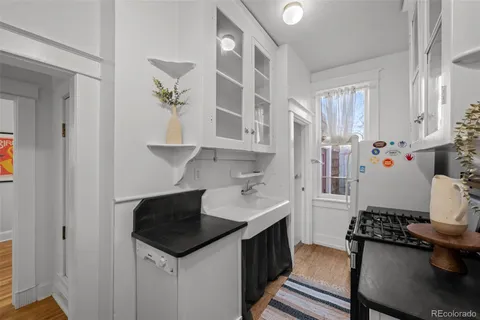 a kitchen with stainless steel appliances a stove a sink and a refrigerator