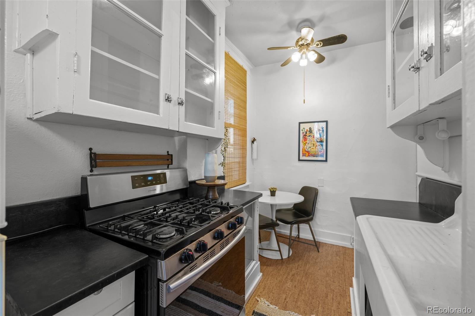 2922 Welton Street Denver, CO 80205 - Photo 15 of 42 a kitchen with stainless steel appliances granite countertop a stove and a refrigerator