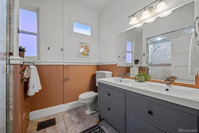 a spacious bathroom with a sink a toilet and mirror