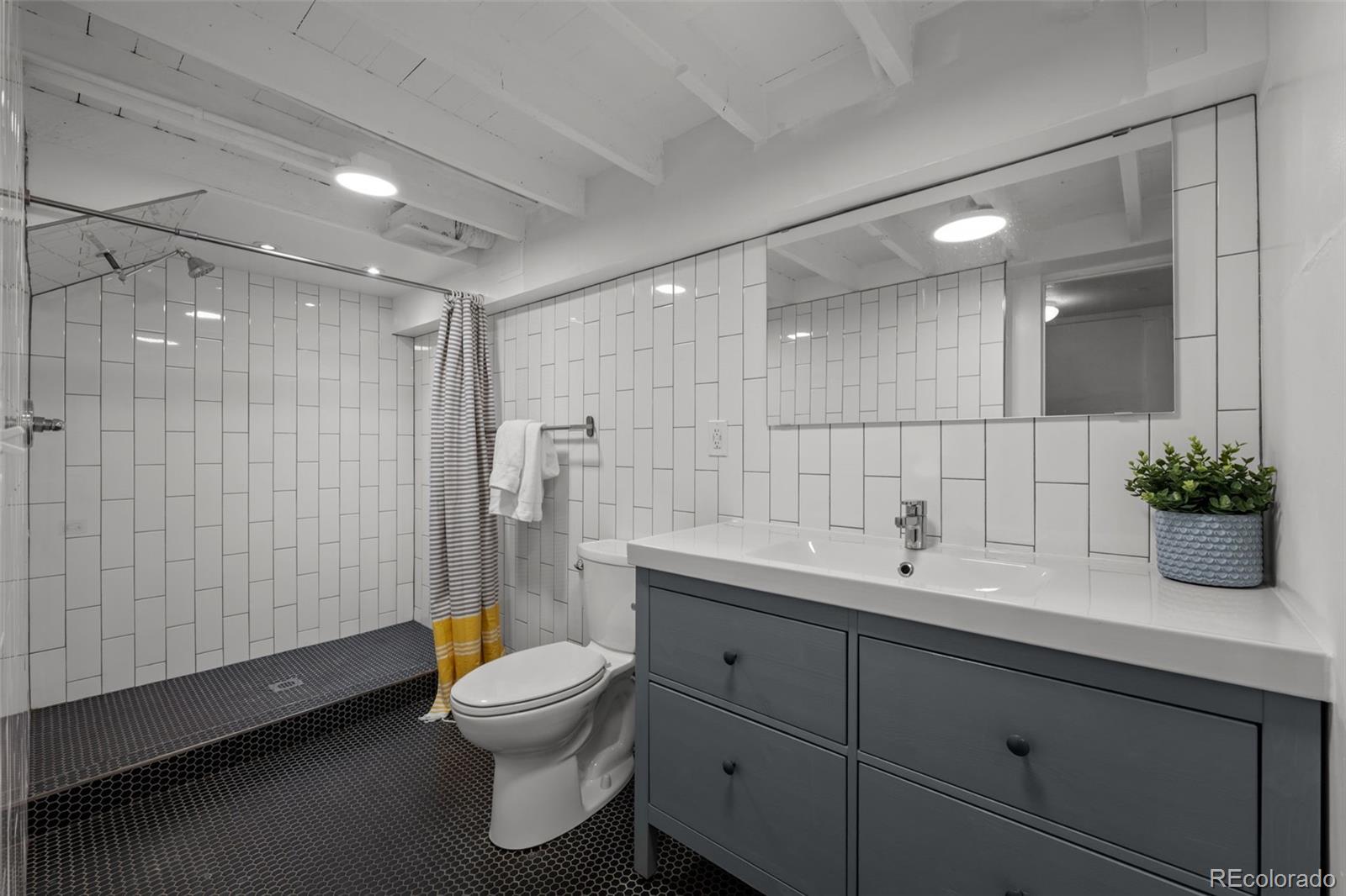 2922 Welton Street Denver, CO 80205 - Photo 20 of 42 a bathroom with a sink toilet and shower