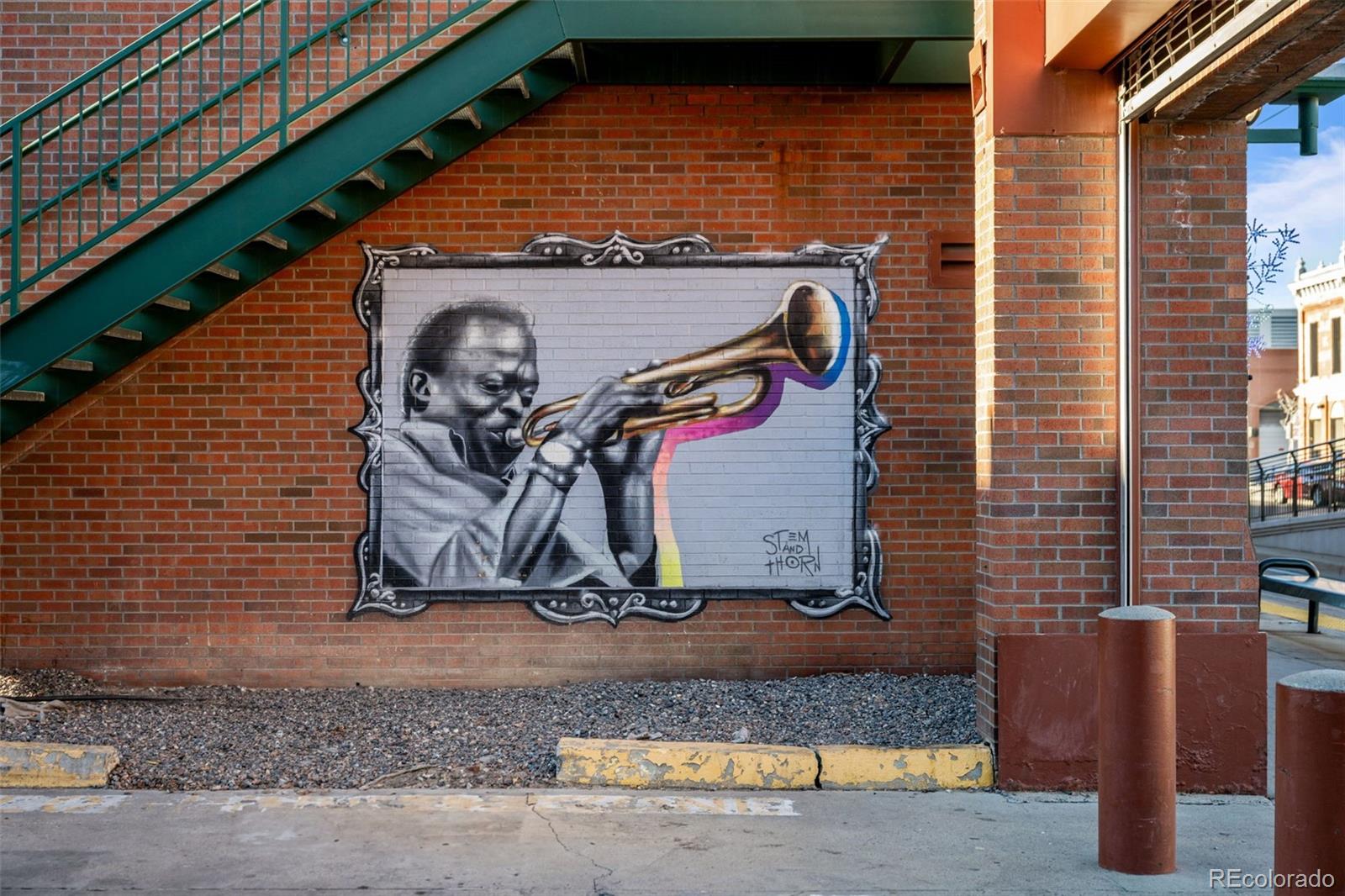 2922 Welton Street Denver, CO 80205 - Photo 37 of 42 a front view of a house with parking area