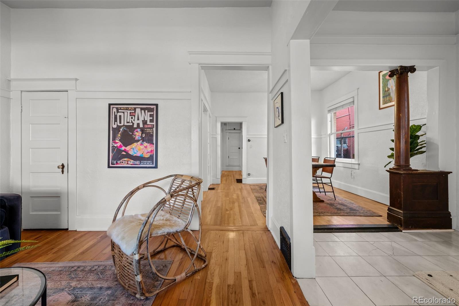 2922 Welton Street Denver, CO 80205 - Photo 8 of 42 a bed room with a bed and a potted plant