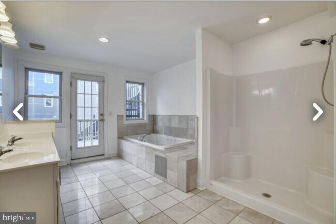 111 East Cross Street Baltimore, MD 21230 - Photo 17 of 36 a bathroom with a sink a counter top space and a shower