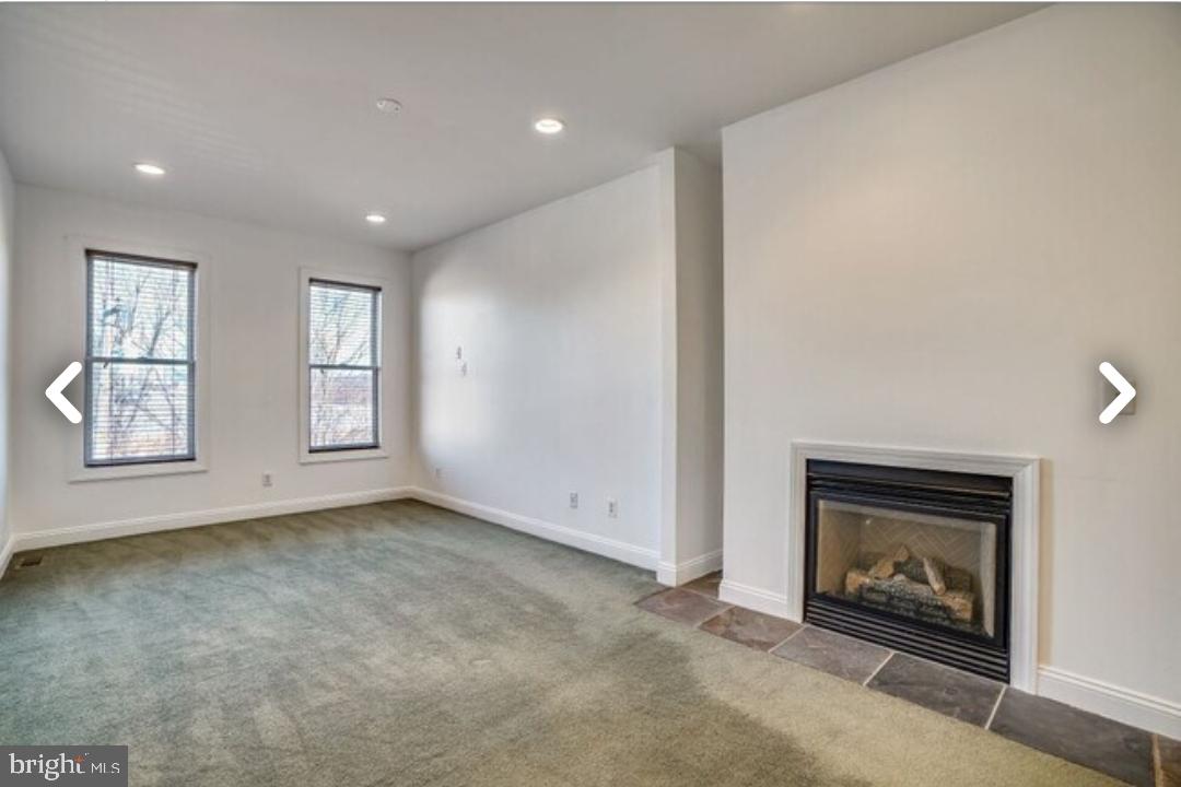 111 East Cross Street Baltimore, MD 21230 - Photo 18 of 36 an empty room with windows a fireplace