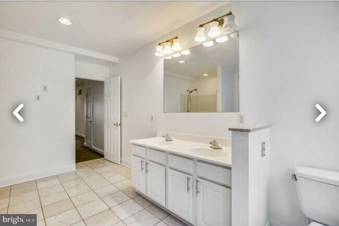 111 East Cross Street Baltimore, MD 21230 - Photo 20 of 36 a spacious bathroom with a double vanity sink mirror and toilet