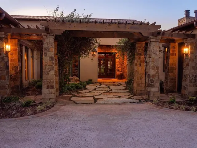 an aerial view of a house with garden space and a lake view