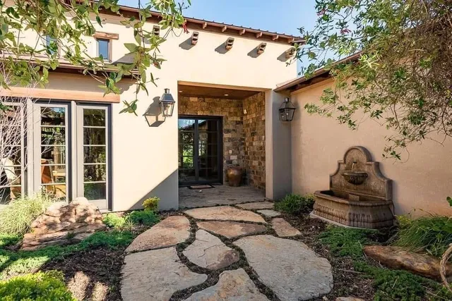 an aerial view of a house with a yard and lake view