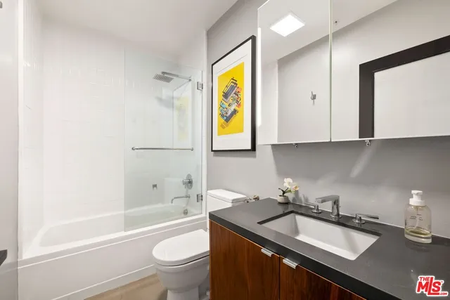 a bathroom with a sink a toilet and bathtub