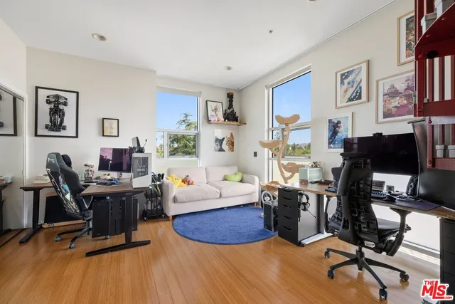 a view of a livingroom with workspace and a couch