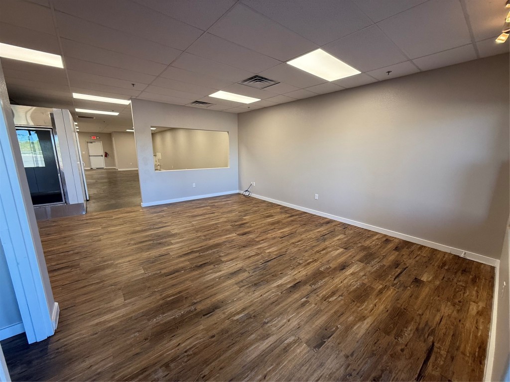 1101 Bunton Creek Road Kyle, TX 78640 - Photo 11 of 17 an empty room with wooden floor and windows