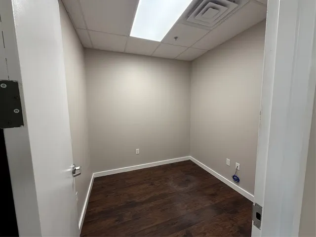 an empty room with a projector and furniture