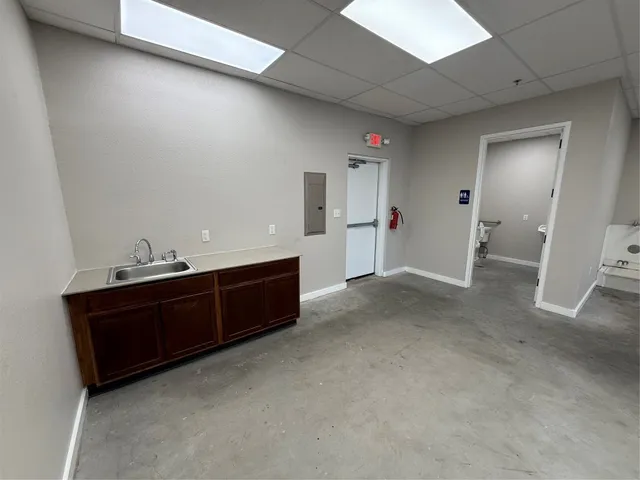 a white toilet sitting next to a white sink