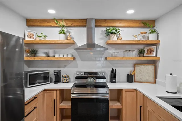 a kitchen with stainless steel appliances granite countertop a stove and a refrigerator