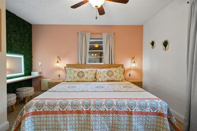 a bedroom with a large bed and a flat tv screen