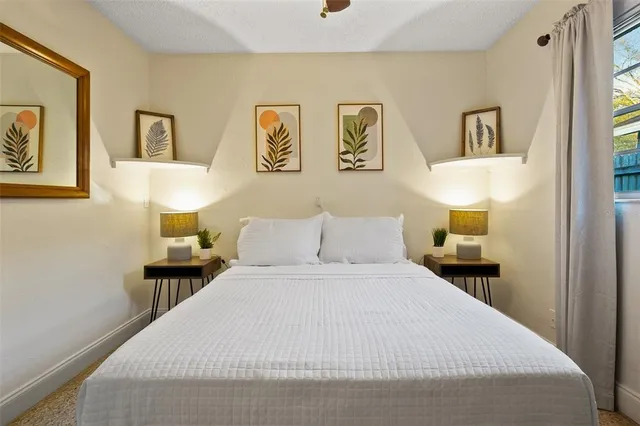 a bedroom with a bed and a lamp