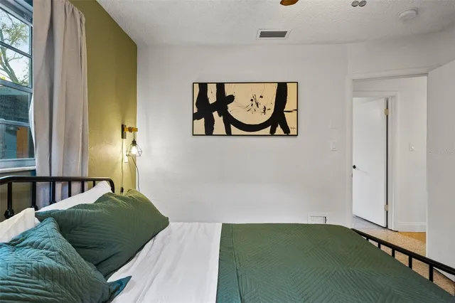 a bedroom with a bed and window