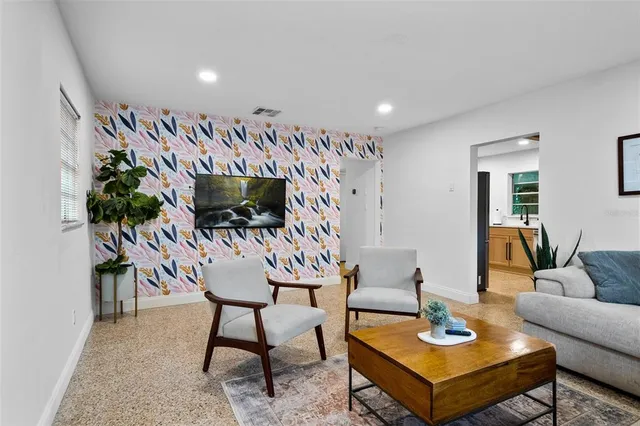 a living room with furniture and wooden floor