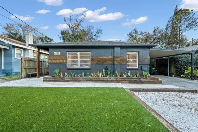 a front view of a house with a yard table and chairs