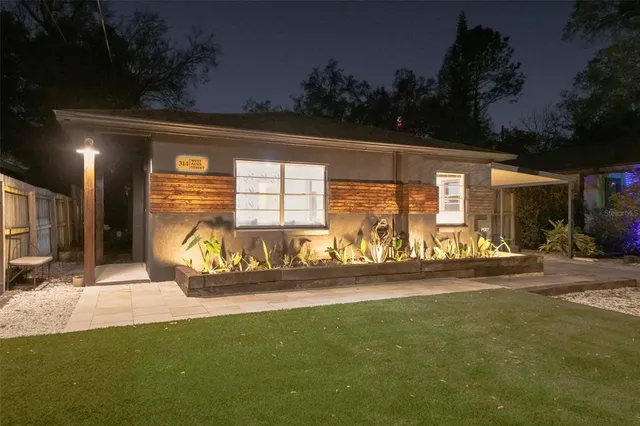 a front view of a house with a garden