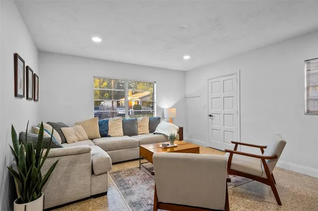 a living room with furniture and a large window