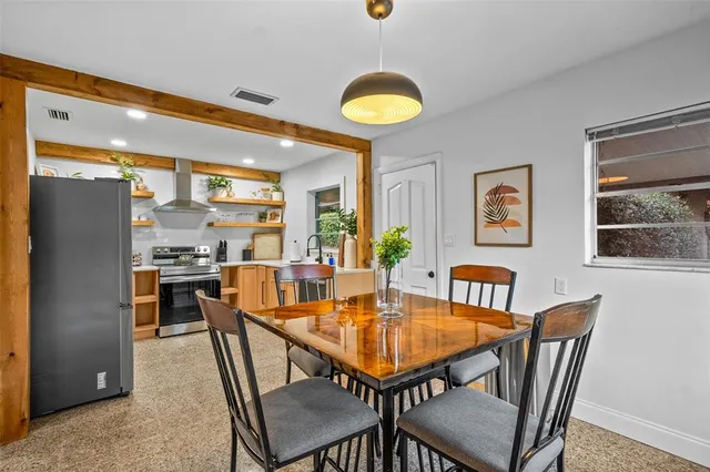 a dining room with furniture and window