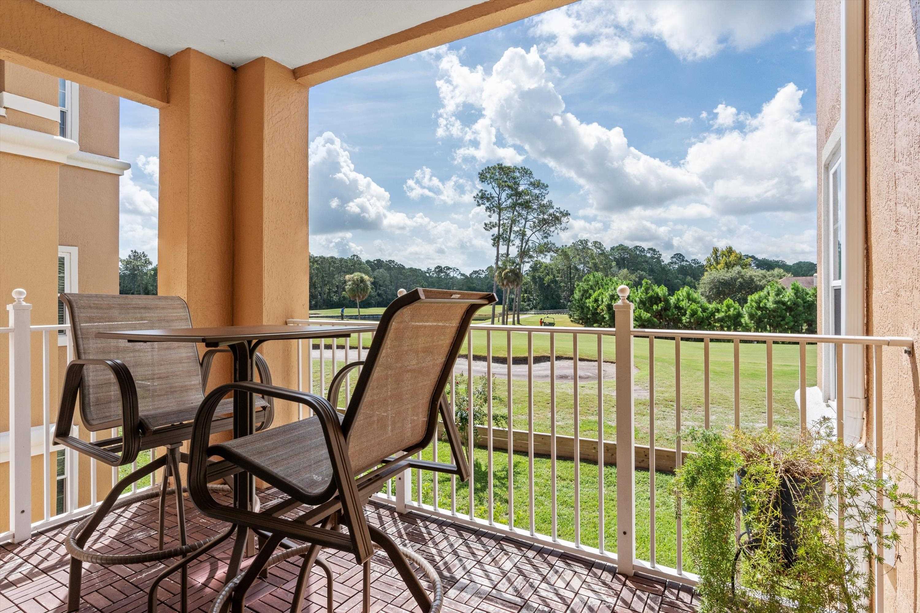 Balcony featuring view of scattered trees
