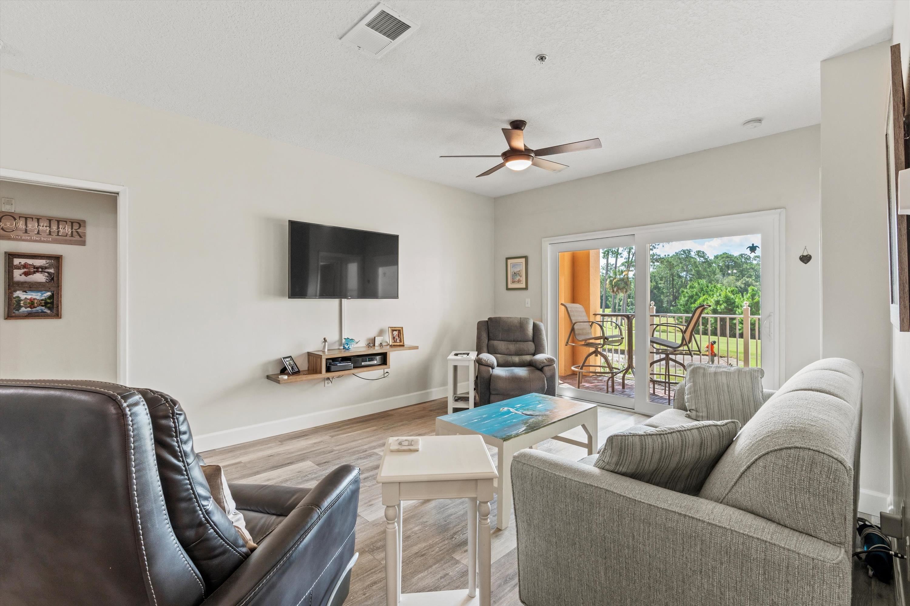 540 Florida Club Boulevard, Unit 210 St. Augustine, FL 32084 - Photo 11 of 33 Living room featuring wood finished floors and ceiling fan