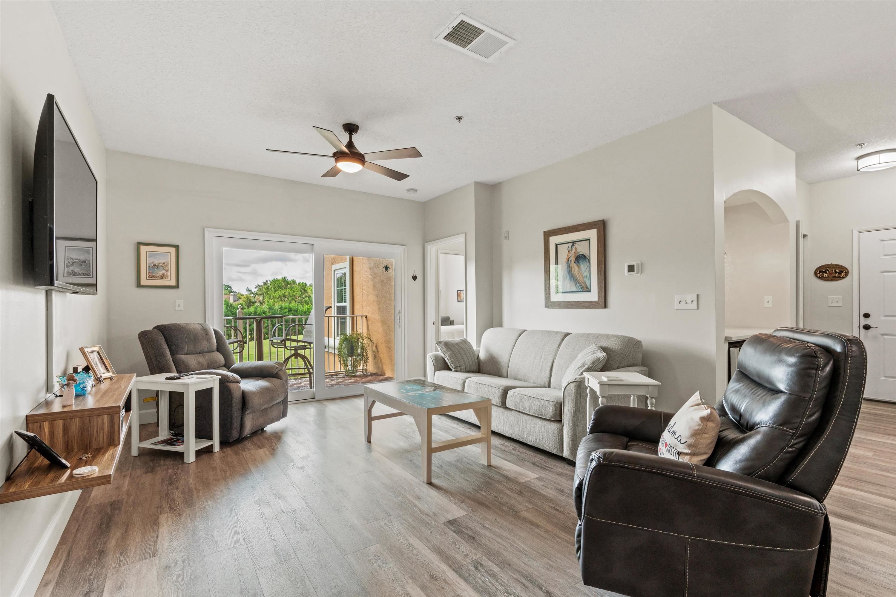 540 Florida Club Boulevard, Unit 210 St. Augustine, FL 32084 - Photo 12 of 33 Living area with light wood finished floors, a ceiling fan, and arched walkways