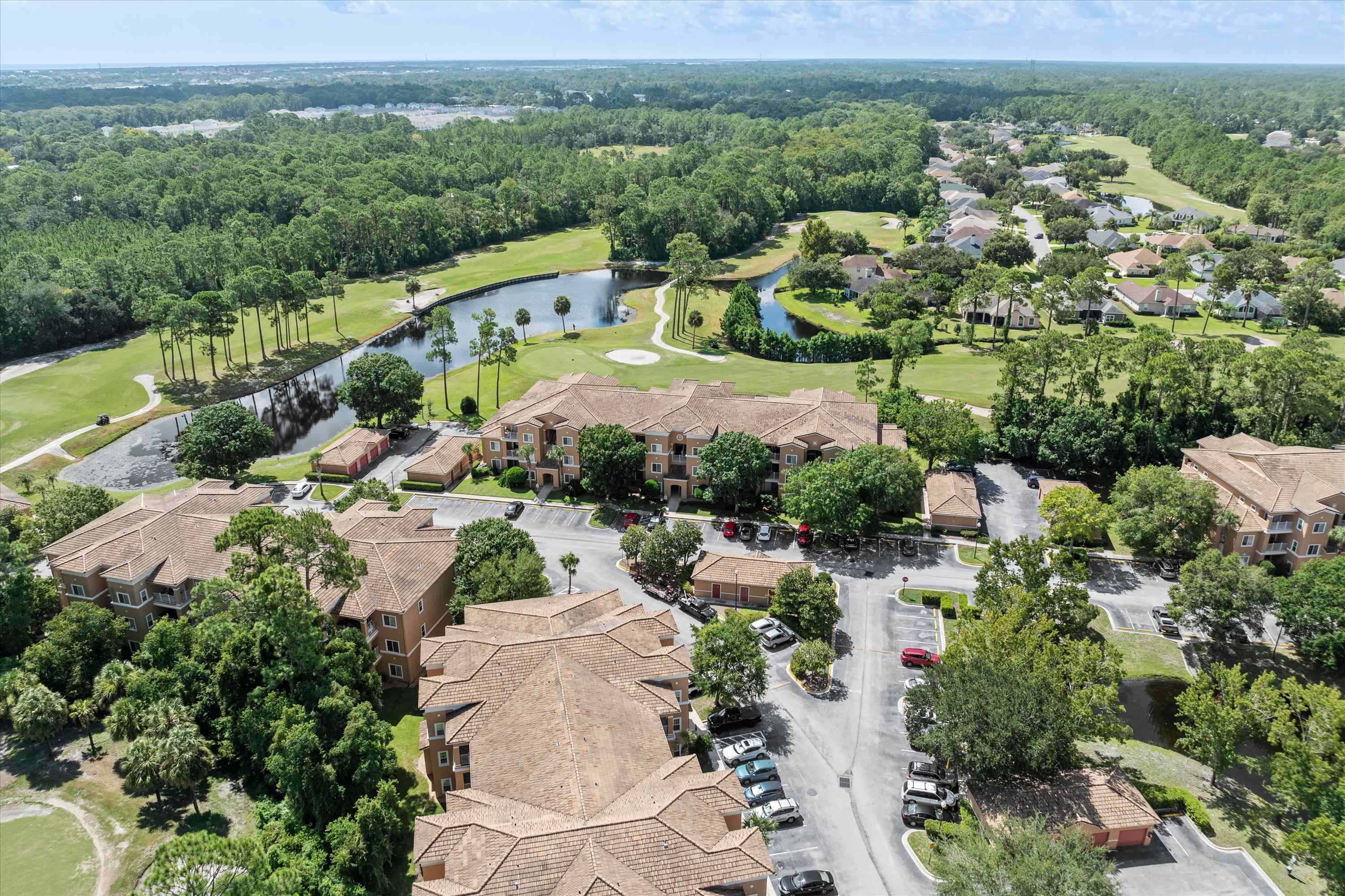 540 Florida Club Boulevard, Unit 210 St. Augustine, FL 32084 - Photo 22 of 33 Aerial overview of property's location featuring a local golf course, a nearby body of water, and nearby suburban area