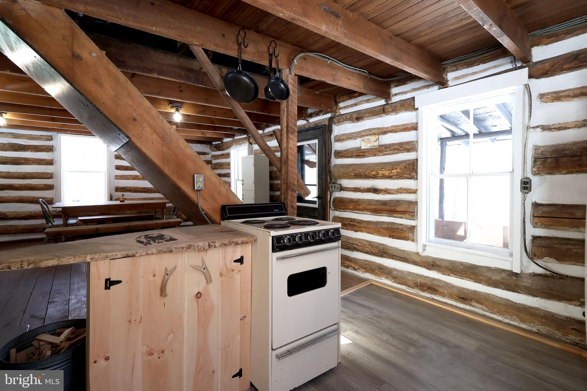 4464 Tram Road Spruce Creek, PA 16683 - Photo 25 of 53 a view of a kitchen with an empty space and wooden floor