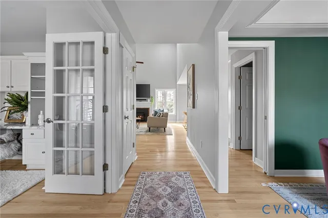 a view of a hallway with wooden floor and staircase