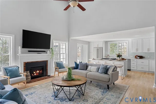 a living room with furniture a fireplace and a flat screen tv