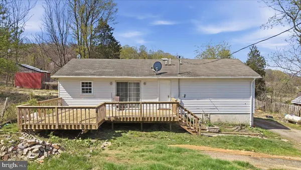 a view of a house with a yard and deck