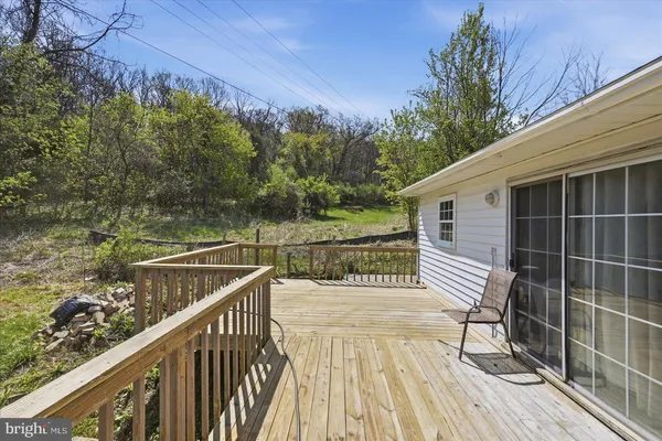 a view of balcony with wooden floor and fence