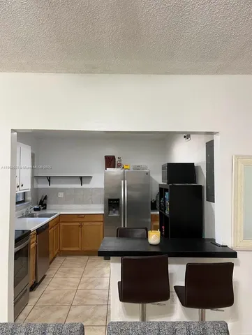 a kitchen with a sink and white cabinets