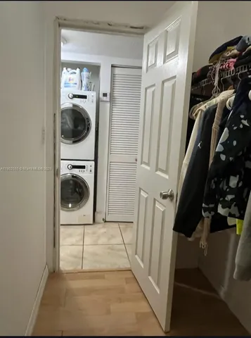 a view of a storage and utility room with a washer dryer