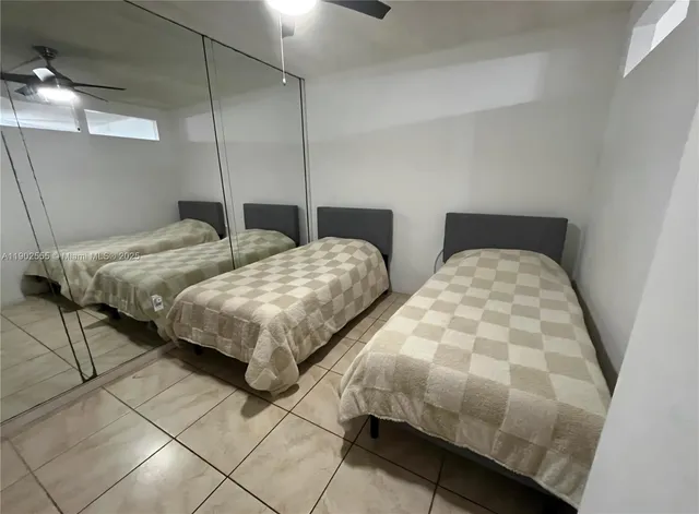 a bedroom with two beds and a lamp