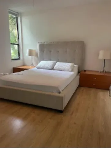 a bed room with a bed and a lamp