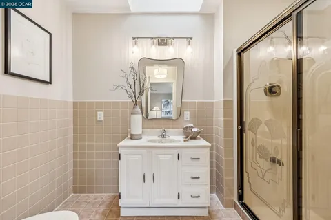a bathroom with a sink mirror and a shower