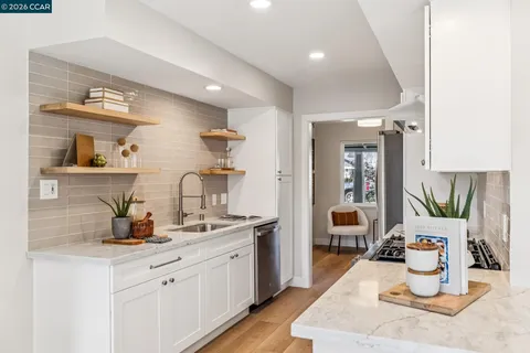 a kitchen with sink and cabinets