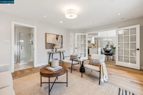 a living room with furniture and a glass door shower