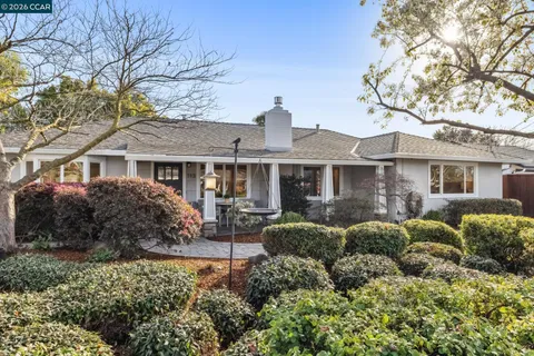 a front view of a house with a yard and outdoor seating
