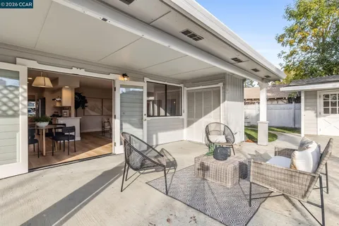 a view of a patio with table and chairs and potted plants
