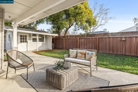 a view of a backyard with a garden and entertaining space