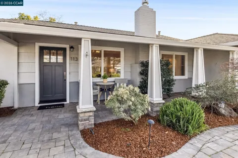 a view of a house with potted plants