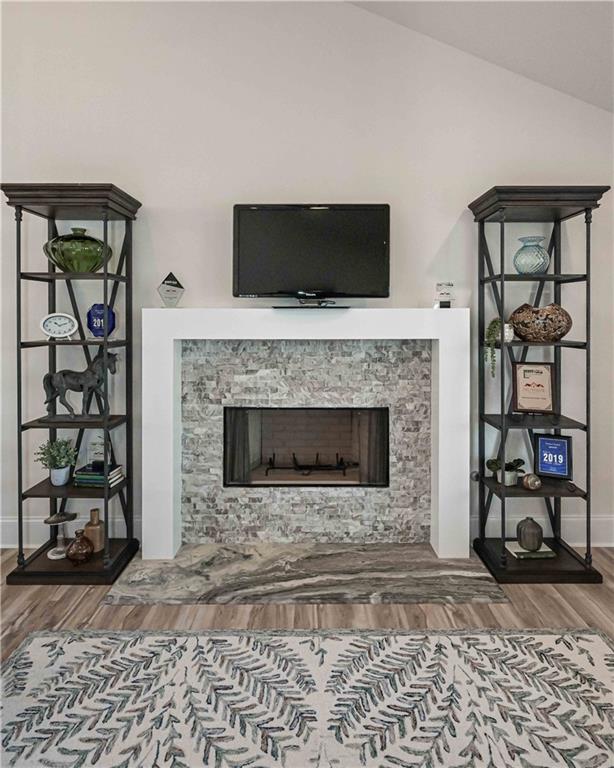 3667 Jones Mill Road Carrollton, GA 30116 - Photo 12 of 66 a living room with a fireplace and a flat screen tv