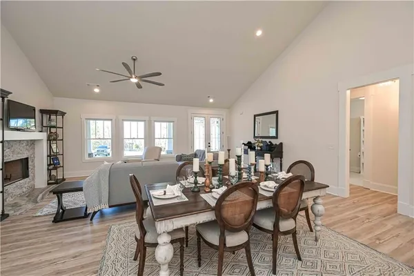 a kitchen with granite countertop white cabinets and stainless steel appliances