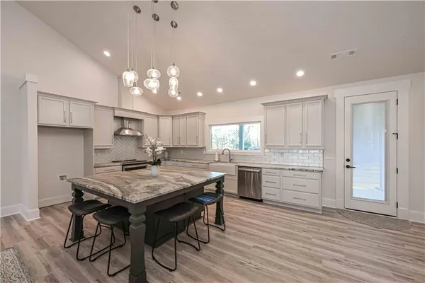 a large kitchen with a table and chairs